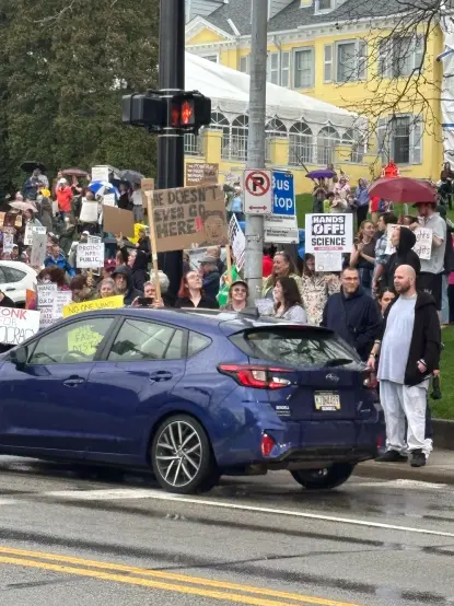 Crowd of people holding signs as cars drive by. The yellow Pittsburgh Arts Center is in the background.  I didn’t take this photo, it’s on a local Reddit board.