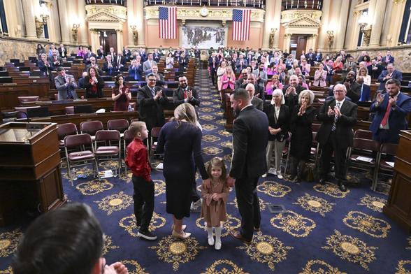 Members of the state General Assembly applaud State Rep. Dan Goughnour and his family after a swearing-in ceremony on Monday.