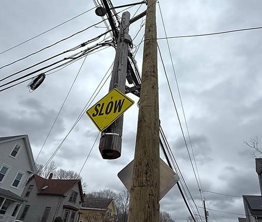 Stumpy remains of old utility pole connected to new pole
