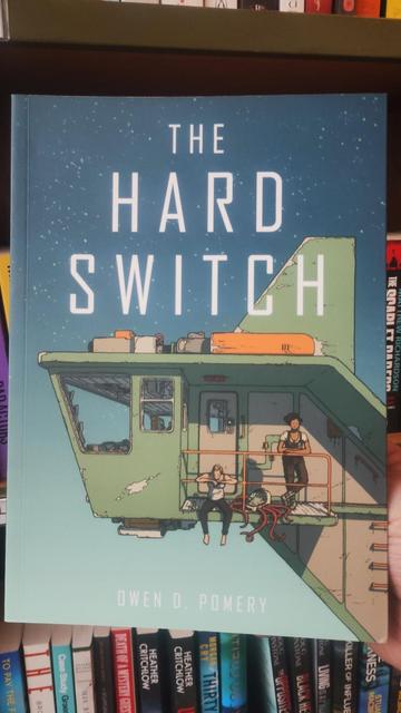 Cover for the Hard Switch by Owen D Pomery, showing two women relaxing on the side of a landed spaceship