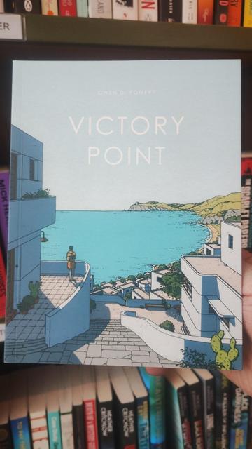 Cover for Victory Point, showing a 1930s Modernist village overlooking a sunlit coastal scene
